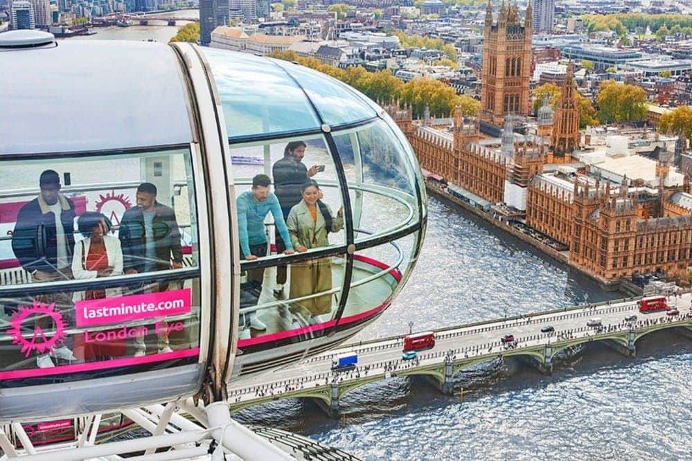 London Eye & SEA LIFE London: Entry Ticket People inside a glass capsule of the London Eye, overlooking the River Thames and Westminster Bridge on a sunny day.